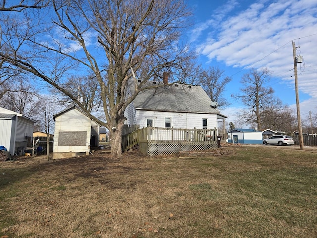 exterior space featuring a deck and a lawn