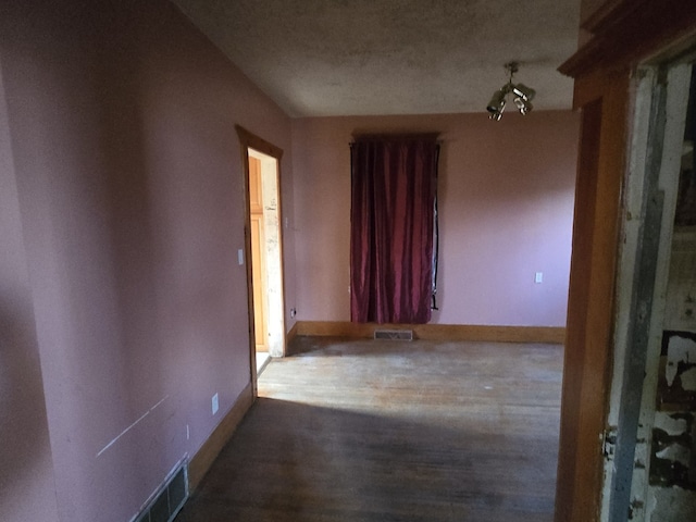 hallway with hardwood / wood-style floors