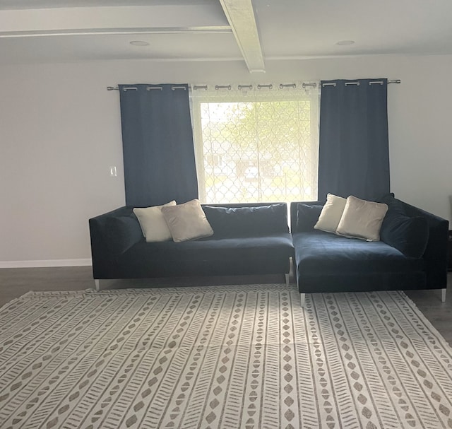 living room featuring beamed ceiling and hardwood / wood-style flooring