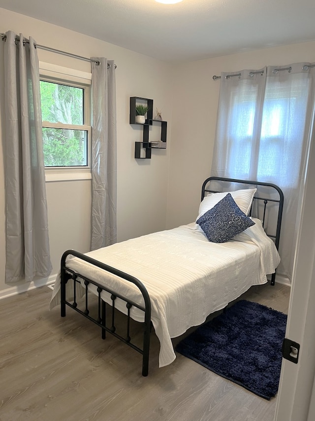 bedroom with wood-type flooring