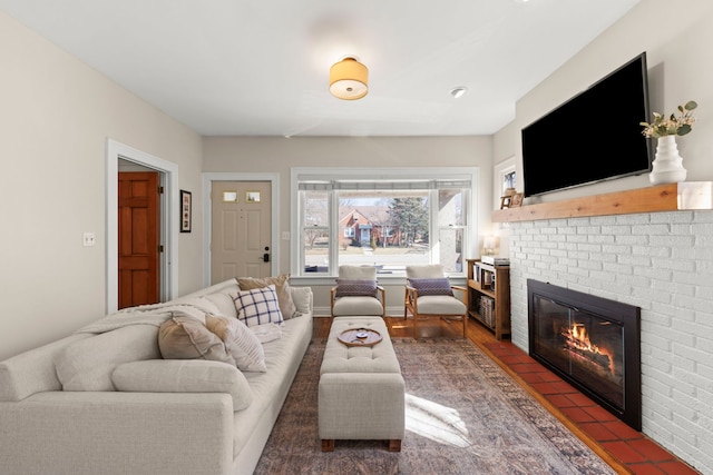 living room featuring a brick fireplace