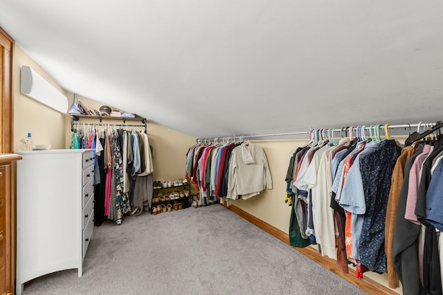 walk in closet with lofted ceiling and carpet flooring