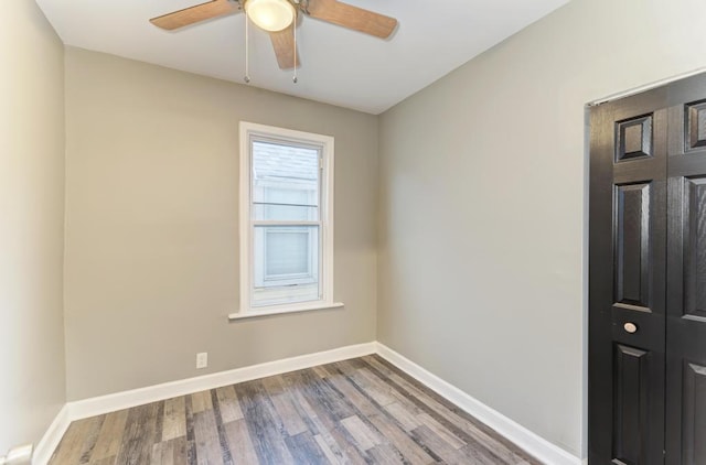 spare room with hardwood / wood-style flooring and ceiling fan