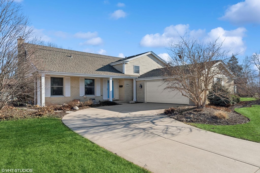 view of front of house with a garage and a front lawn