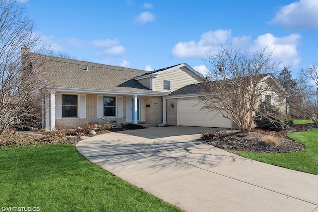 view of front of house with a garage and a front lawn