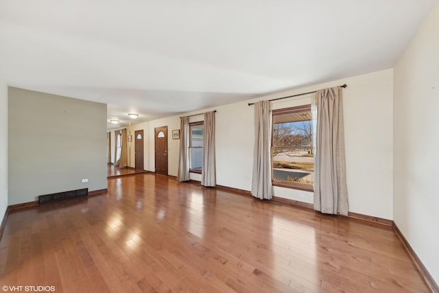 spare room with wood-type flooring