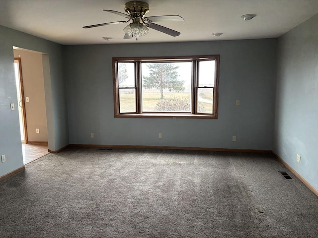 empty room with ceiling fan and carpet floors