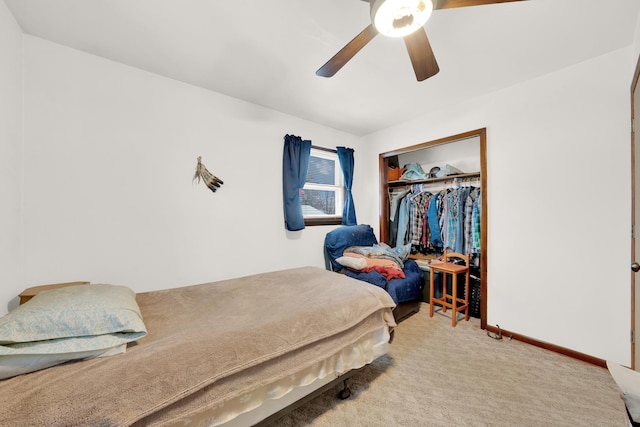 carpeted bedroom featuring ceiling fan and a closet