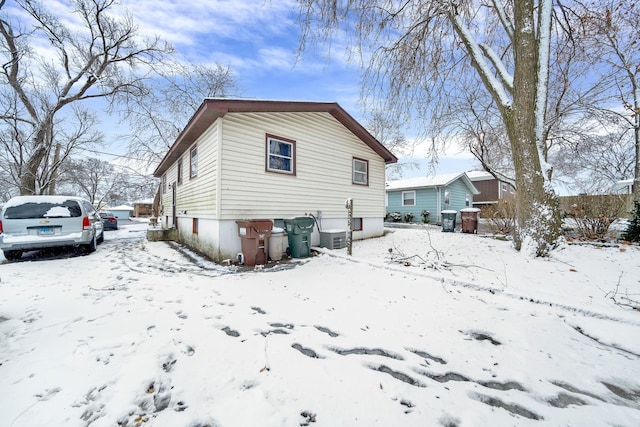 view of snow covered rear of property