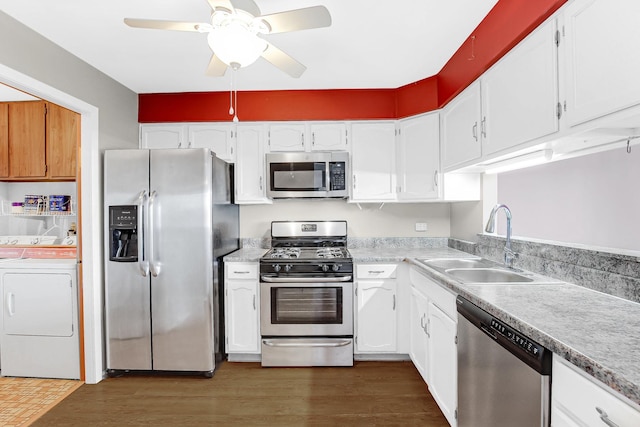 kitchen featuring white cabinets, washer / dryer, stainless steel appliances, and sink