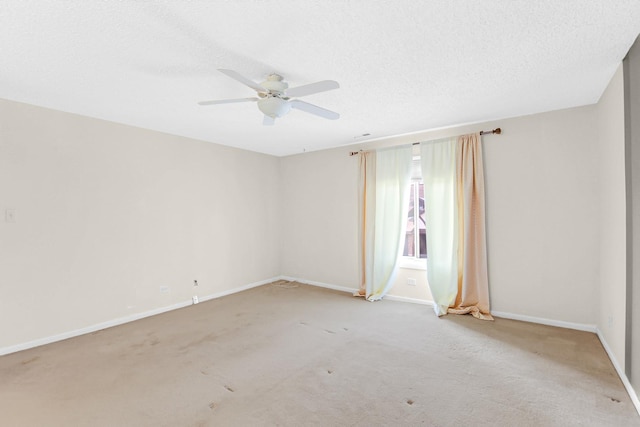 carpeted spare room featuring ceiling fan and a textured ceiling