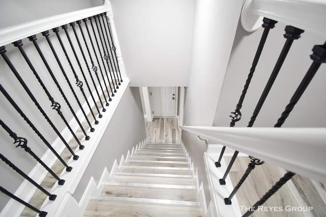 stairway with hardwood / wood-style flooring