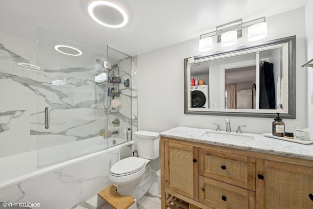 full bathroom featuring vanity, washer / clothes dryer, toilet, and enclosed tub / shower combo