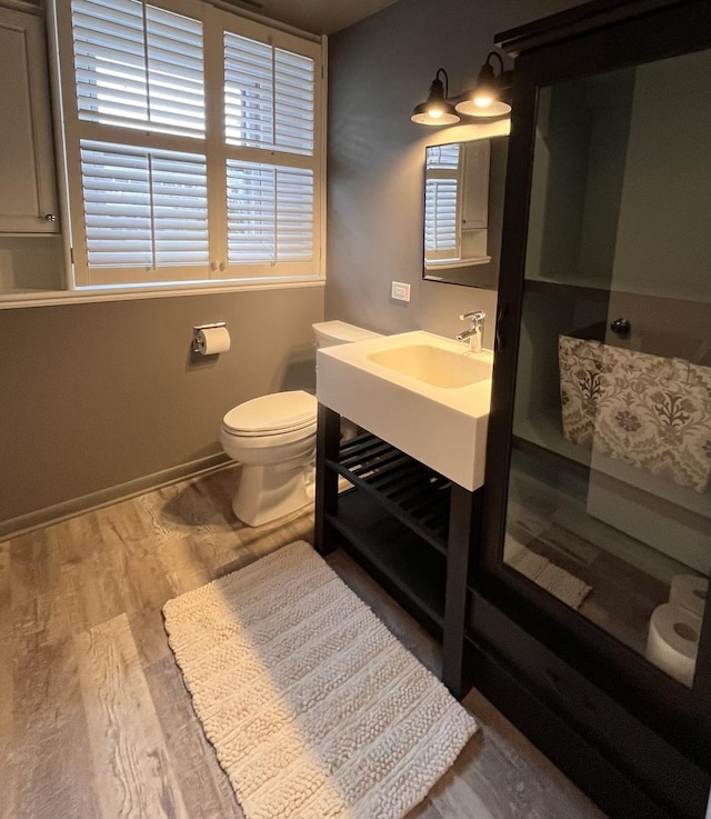 bathroom featuring hardwood / wood-style flooring, toilet, and vanity