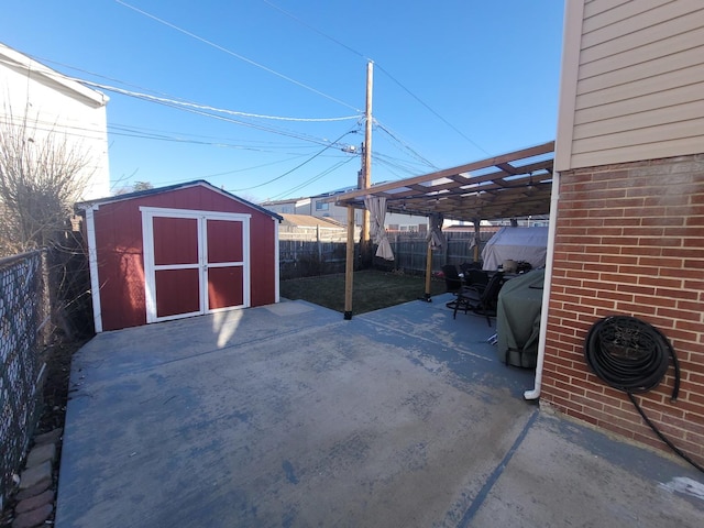 view of patio / terrace with a pergola and a shed