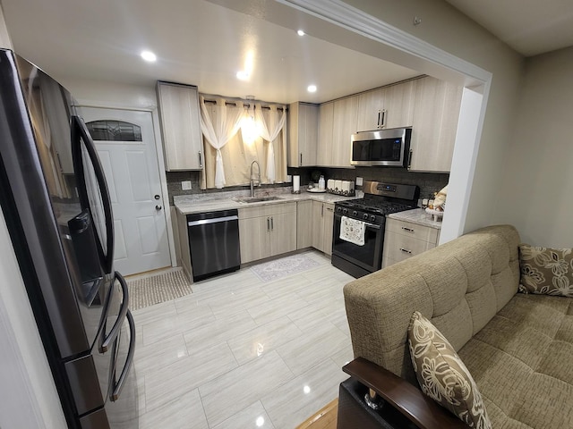 kitchen featuring tasteful backsplash, sink, light tile patterned floors, and appliances with stainless steel finishes