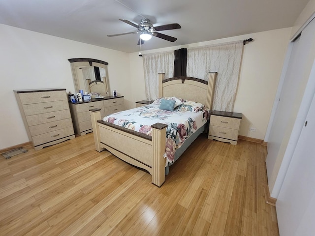 bedroom featuring ceiling fan, a closet, and light hardwood / wood-style flooring