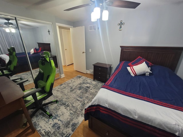 bedroom featuring hardwood / wood-style floors, ceiling fan, and a closet