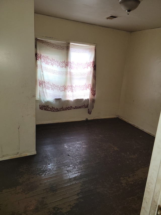 spare room with dark wood-type flooring