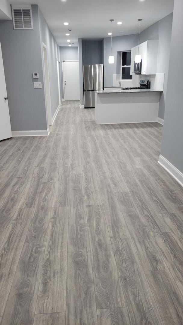 1918 S Kedzie Ave, Chicago, IL 60623 - unfurnished living room featuring light wood-type flooring, baseboards, and recessed lighting
