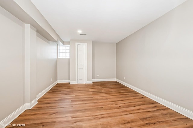 basement with light hardwood / wood-style flooring