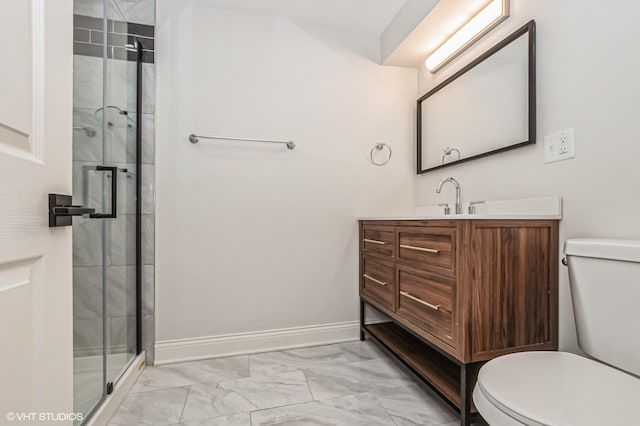 bathroom with vanity, a shower with shower door, and toilet