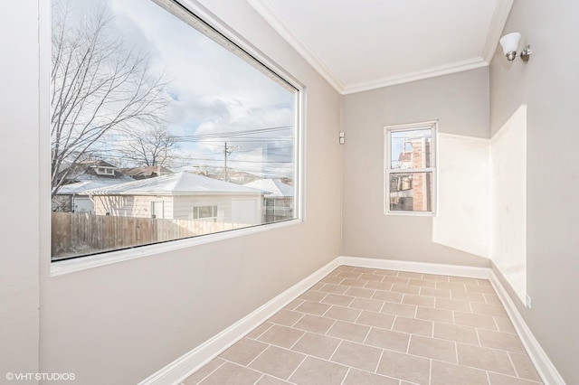 spare room with tile patterned floors and ornamental molding