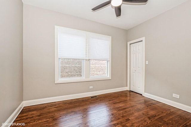 unfurnished room featuring dark hardwood / wood-style flooring and ceiling fan