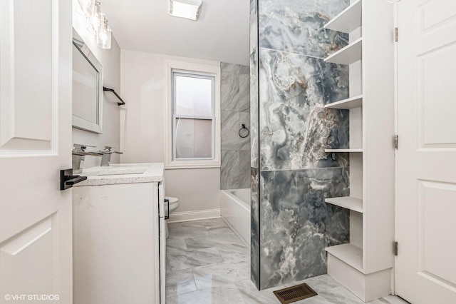 full bathroom featuring vanity, toilet, and tiled shower / bath