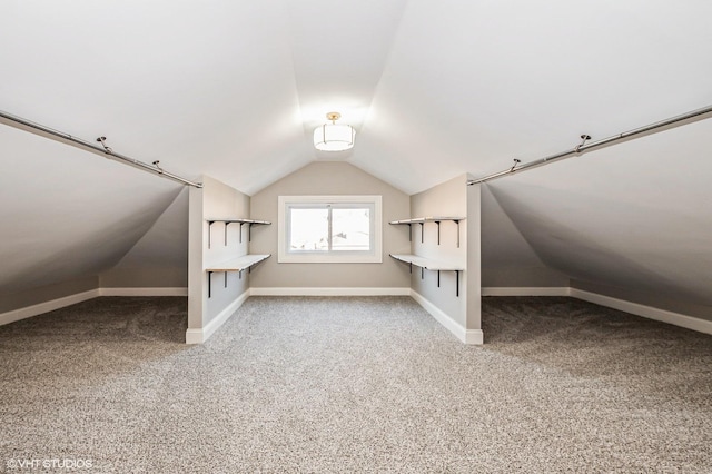 additional living space with carpet flooring and lofted ceiling