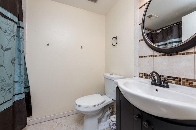 bathroom with vanity, backsplash, tile patterned flooring, toilet, and walk in shower