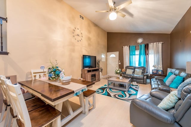 living room with ceiling fan and lofted ceiling