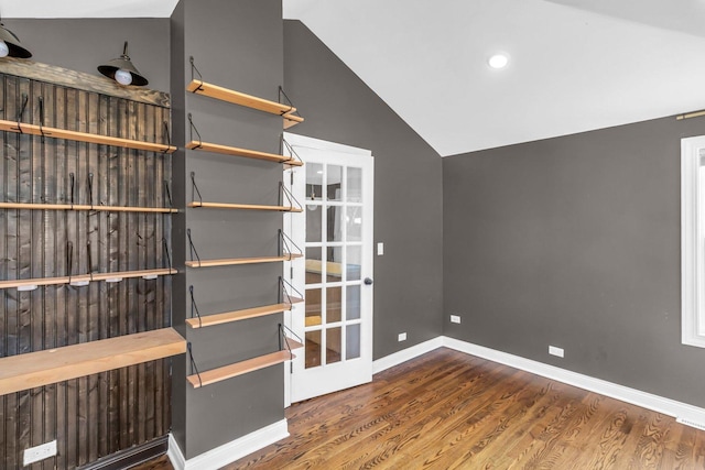 interior space featuring lofted ceiling and dark hardwood / wood-style flooring