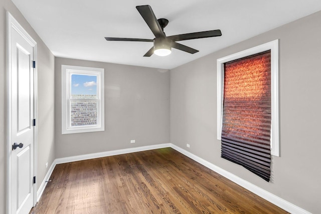 unfurnished room featuring ceiling fan and dark hardwood / wood-style floors