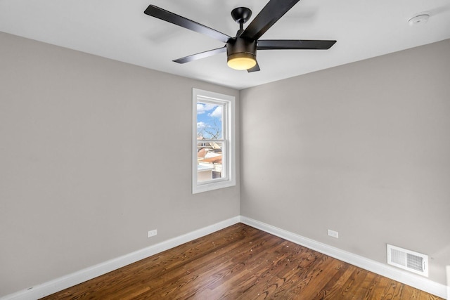 unfurnished room with dark wood-type flooring and ceiling fan