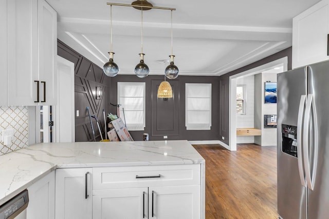 kitchen featuring stainless steel appliances, white cabinetry, decorative light fixtures, and light stone countertops