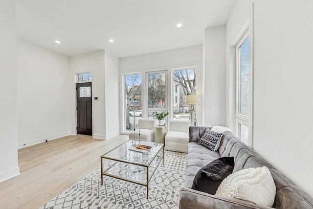 living area with light wood-style floors, recessed lighting, and baseboards