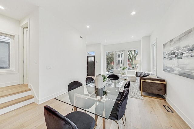 dining space with light wood finished floors, baseboards, and recessed lighting