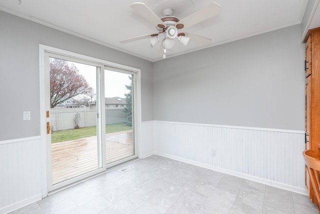 empty room featuring ceiling fan and ornamental molding