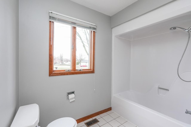 bathroom with toilet, shower / tub combination, and tile patterned floors