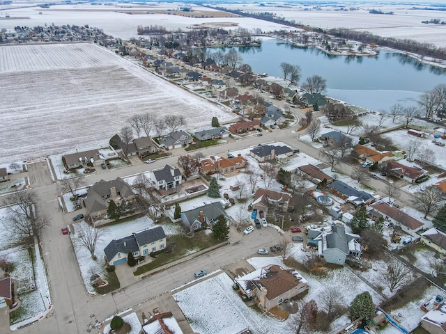 snowy aerial view featuring a water view