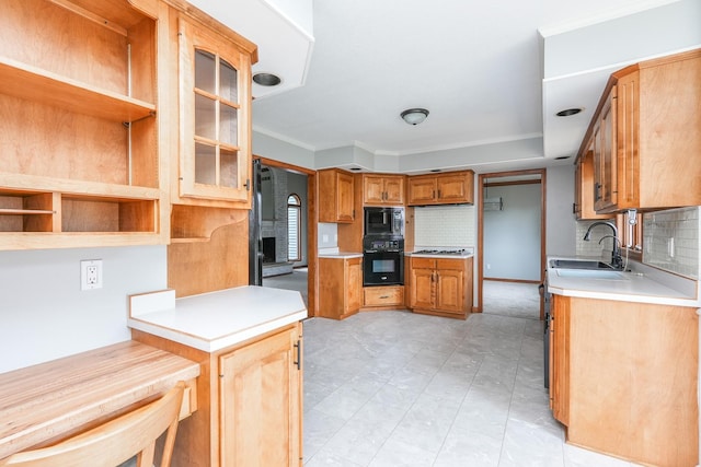 kitchen featuring built in microwave, sink, tasteful backsplash, crown molding, and black oven