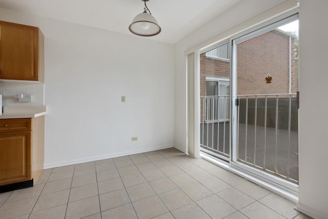 unfurnished dining area featuring light tile patterned floors