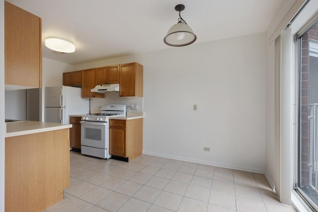 kitchen featuring plenty of natural light, hanging light fixtures, and white gas stove