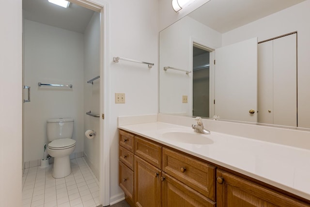 bathroom featuring tile patterned floors, vanity, and toilet