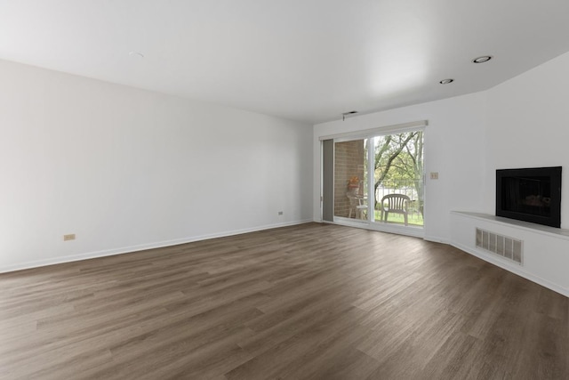 unfurnished living room featuring dark hardwood / wood-style floors