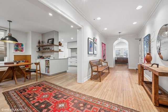 hall featuring light hardwood / wood-style floors and ornamental molding