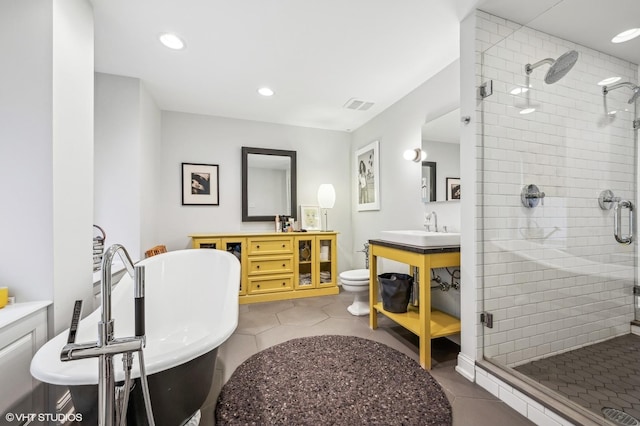 full bathroom with tile patterned flooring, vanity, toilet, and independent shower and bath