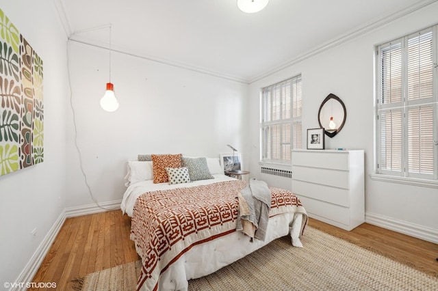 bedroom featuring wood-type flooring and ornamental molding