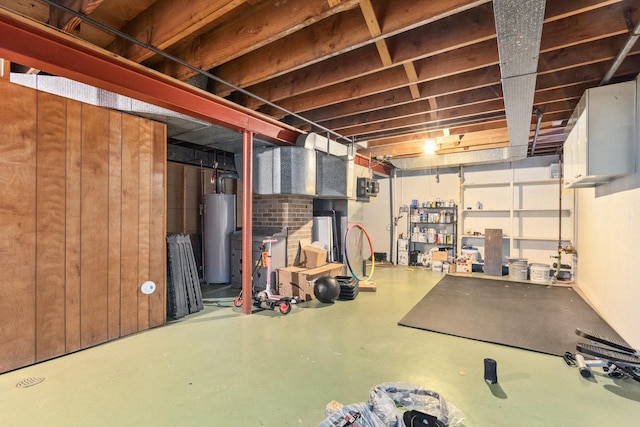 basement with gas water heater and wood walls